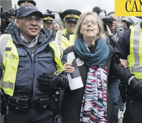  ?? DARRYL DYCK / THE CANADIAN PRESS ?? Green Party Leader Elizabeth May is arrested by RCMP officers after joining a protest against the expansion of Kinder Morgan’s Trans Mountain pipeline outside the company’s facility in Burnaby, B.C., on Friday.