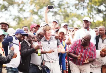  ?? – (Sunshine Tour) ?? TO THE WINNER GOES THE SPOILS . . . South African golfer JJ Senekal is mobbed after winning the Zanaco Masters at the Lusaka Golf Club in Zambia on Sunday.