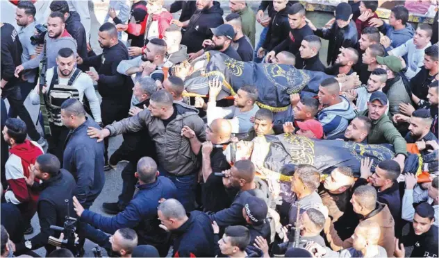  ?? Agence France-presse ?? ↑
Mourners carry the bodies of Muhammad Ayman Al Saadi and Naim Jamal Zubaidi during their funeral in Jenin on Thursday.