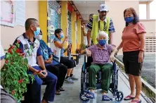  ?? Reuters ?? A woman arrives in a wheelchair to vote during Malaysia’s 15th general election in Bera, Pahang, Malaysia, on Saturday.
