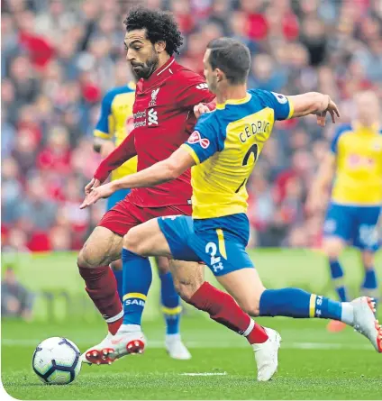  ??  ?? Liverpool’s Mohamed Salah (left) is challenged by Cedric Soares of Southampto­n