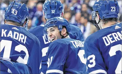  ?? CP PHOTO ?? Toronto Maple Leafs’ John Tavares, centre, celebrates with teammates Nazem Kadri and Travis Dermott after scoring in the second period of Wednesday night’s game against the Montreal Canadiens in Toronto.