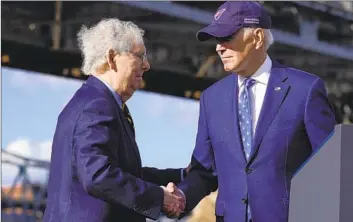  ?? Patrick Semansky Associated Press ?? PRESIDENT BIDEN with Senate Minority Leader Mitch McConnell in Covington, Ky., to promote the repair of a key bridge between Ohio and Kentucky. “We can work together. We can get things done,” Biden said.