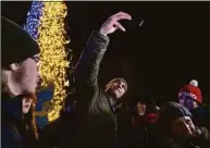  ?? Vasilisa Stepanenko / Associated Press ?? Kyiv Mayor Vitali Klitschko poses for photos with supporters during the inaugurati­on of a Christmas tree decorated with the colors of the Ukrainian national flag in Kyiv, Ukraine, on Monday.