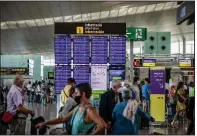  ?? (Bloomberg/Angel Garcia) ?? Passengers wait in the departures hall at El Prat airport in Barcelona, Spain, on Aug. 2.