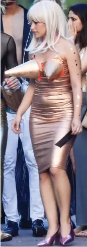  ??  ?? Eye-catching: A conical bra makes this skin-tight shiny dress even more daring