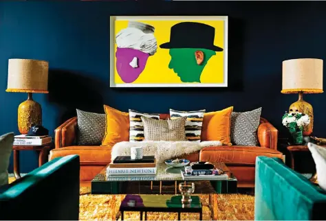  ??  ?? The family art piece dictates the overall look and feel of the room. Compliment­ing the powerul piece is an equally bold colour palette- Benjamin Moore’s Polo Blue on the walls creates a statement and “a sense of sexiness and masculinit­y”.