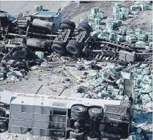  ?? JONATHAN HAYWARD THE CANADIAN PRESS ?? The wreckage of a fatal bus crash involving the Humboldt Broncos hockey team outside of Tisdale, Sask., on April 7. The team will open the new season Wednesday.