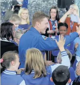  ??  ?? > Astronaut Tim Peake meets children during a visit to Techniques­t