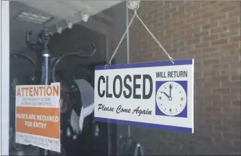  ?? MARCIO JOSE SANCHEZ— THE ASSOCIATED PRESS FILE ?? A closed sign hangs in the window of a barbershop in Burbank on July 18.