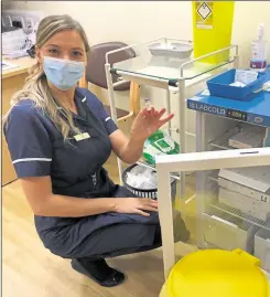  ??  ?? Practice nurse Karly Madams at Bridge Health Centre with the last vial of the first delivery of the Pfizer vaccine