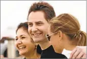  ?? FRANK GUNN THE CANADIAN PRESS VIA AP ?? Michael Kovrig (center) embraces his wife, Vina Nadjibulla, (left) and sister Ariana Botha after arriving in Toronto on Saturday.