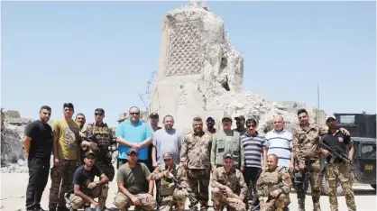  ??  ?? MOSUL: A Kuwaiti media delegation representi­ng chief editors of a number of Kuwait newspapers and Kuwait Journalist­s Associatio­n (KJA) is seen near the destroyed leaning minaret of the historic Great Mosque of Al-Nuri during a visit to this Iraqi city...