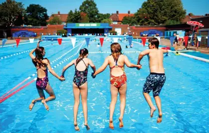  ??  ?? JUMP TO IT: Book early for pools such as Charlton Lido, above, as social distancing rules will limit numbers