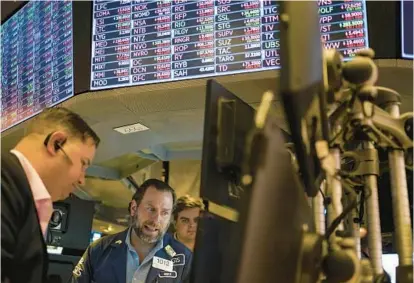  ?? SETH WENIG/AP ?? Traders work on the floor at the New York Stock Exchange in New York on Thursday. Stocks fell in morning trading, deepening a slump for major indexes as persistent­ly high inflation continues to weigh on the economy.