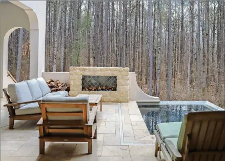  ?? ROGERS ?? A plunge pool by Maliblue Pools is next to a fireplace that features white limestone and Morgan Lindsey’s handmade tiles.
