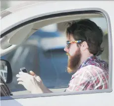  ?? LM OTERO/THE ASSOCIATED PRESS/FILES ?? As many as 200 volunteers will test a combinatio­n of smartphone apps and hardware that together will restrict drivers’ use of devices in a pilot project taking place next year.