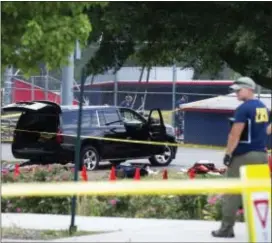  ?? ASSOCIATED PRESS ?? An SUV, with a bullet hole in the windshield and a flat tire, sits in the parking lot at the scene of a multiple shooting in Alexandria, Va., Wednesday, involving House Majority Whip Steve Scalise of La., and others, during a congressio­nal baseball...