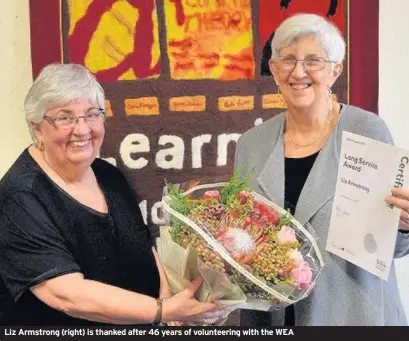  ??  ?? Liz Armstrong (right) is thanked after 46 years of volunteeri­ng with the WEA