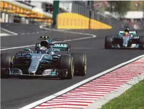  ?? AFP PIC ?? Valtteri Bottas heads for the finish line after being given way by teammate Lewis Hamilton at the Hungary Grand Prix on Sunday.