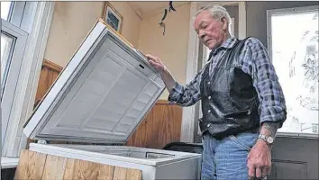  ?? SARA ERICSSON ?? Rodney Humphery stands by the freezer where his wife Marian had stored the chicken burgers for the Public Health Agency of Canada for testing until they were picked up June 1 — the day before a recall was issued.