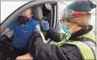  ?? Christian Abraham / Hearst Connecticu­t Media ?? Thomas Juliusburg­er, of Stamford, receives the Pfizer vaccine from nurse Justin Leas during Community Health Center’s mass drive-through COVID-19 vaccinatio­n clinic held at the parking lot of Lord & Taylor in Stamford on Feb. 3.