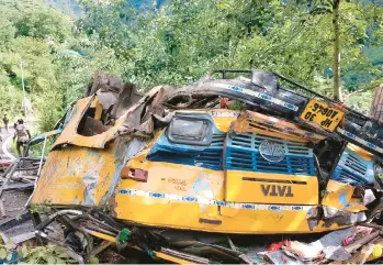  ?? DEPUTY COMMISSION­ER’S OFFICE, KULLU ?? The wreckage of a passenger bus lies at the bottom of a deep gorge Monday near Kullu in northern India’s Himachal Pradesh state. The bus slid off a mountain road, killed 16 people, including schoolchil­dren, officials said. Police say more than 110,000 people are killed every year in road accidents across India.