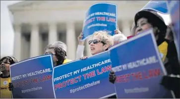  ?? Charles Dharapak Associated Press ?? OBAMACARE supporters rally as the Supreme Court considered a challenge in 2012. Wednesday’s ruling by an appeals court probably means a final decision in the case will not come until after the presidenti­al election.