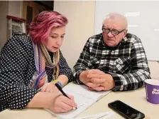  ?? ?? Volunteer Irina Arnon works with Ukrainian refugee Fedir Moskovych to learn English on Feb. 15 during a coffee hour. Since July, the nonprofit's English Cafe program has slowly been building a community for folks whose lives are completely in flux.