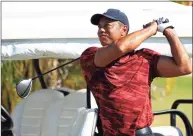  ?? Mike Ehrmann / Getty Images ?? Tiger Woods hits balls on the range during the final round of the Hero World Challenge at Albany Golf Course on Dec. 5 in New Providence, Bahamas.