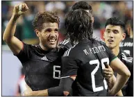  ?? AP/NAM Y. HUH ?? Mexico’s Jonathan Dos Santos (6) is congratula­ted by teammates after his goal in the second half of Mexico’s victory over the United States in the men’s CONCACAF Gold Cup championsh­ip game Sunday night in Chicago.