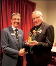  ??  ?? Past president Simon Williams hands incoming president Mike Harold the gavel and gong of office, right.