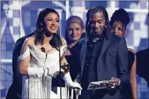  ?? PHOTO BY MATT SAYLES/INVISION/AP ?? Cardi B accepts the award for best rap album for “Invasion of Privacy,” as Offset looks on at the 61st annual Grammy Awards on Sunday in Los Angeles.