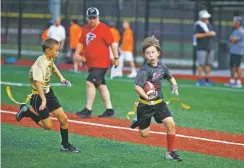  ?? MELISSA GOLDEN/THE NEW YORK TIMES ?? Hayden Hannah runs the ball Sept. 25 during a game in a youth recreation­al flag football league in Hoover, Ala. More American children ages 6 to 12 now play flag football than the tackle version of the sport. The NFL has taken note and is investing in the game.