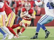  ?? Scott Strazzante/The Chronicle ?? San Francisco running back Christian McCaffrey carries the ball against the Cowboys on Jan. 22 in Santa Clara, Calif.