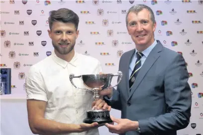  ?? Www.mphotograp­hic.co.uk ?? ●●Jason Oswell receives County’s Player of the Season award from boss Jim Gannon during the club’s end of season awards ceremony. See pages 66 and 67