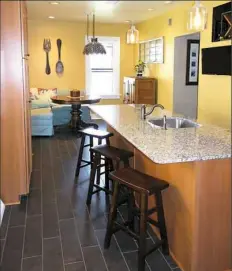  ??  ?? New banquette seating in the corner of the kitchen hugs a round pedestal table.