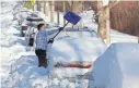  ?? ROBERT F. BUKATY/AP ?? A woman in Portland, Maine, digs her car out Wednesday after a powerful nor’easter rocked the region with blizzard conditions.