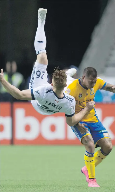  ?? — CP ?? Vancouver Whitecaps’ Tim Parker, left, falls to the ground after colliding with Tigres’ Eduardo Vargas Wednesday during their second-leg CONCACAF Champions League semifinal at B.C. Place.