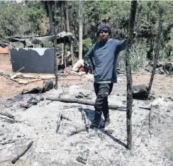  ?? NKULULEKO NENE ?? FIRE victim Xolani Ndlovu standing on the ashes of his shack. |