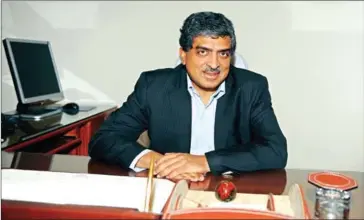  ?? AVEENDRAN/AFP ?? Nandan Nilekani poses in his office in New Delhi on July 23, 2009, after being made the head of the ‘Unique Identifica­tion Card’ programme, a multipurpo­se database of citizens details.