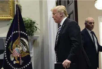  ?? AP FILE PHOTOS ?? EXIT STRATEGY: Chief of staff John Kelly, also left, stands in the background as President Trump enters the Roosevelt Room of the White House last month to discuss immigratio­n and border security.