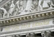  ?? ASSOCIATED PRESS FILE PHOTO ?? Stone sculptures adorn the New York Stock Exchange building in Manhattan.