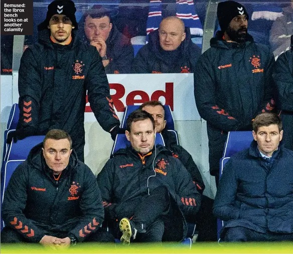  ??  ?? Bemused: the Ibrox bench looks on at another calamity