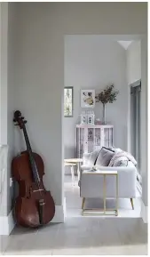  ??  ?? A vintage cello displayed alongside a sleek gold side table is a prime example of Gillian’s savvy mixing of styles