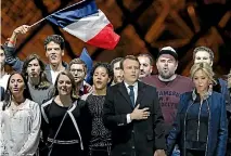  ?? PHOTO: REUTERS ?? French President elect Emmanuel Macron and his wife Brigitte Trogneux celebrate on the stage at his victory rally near the Louvre in Paris.