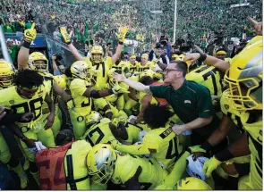  ?? AP/THOMAS BOYD ?? Oregon running back CJ Verdell (34) reaches out to a fan after scoring the winning touchdown in overtime, lifting the No. 17 Ducks past No. 7 Washington 30-27 in overtime on Saturday.