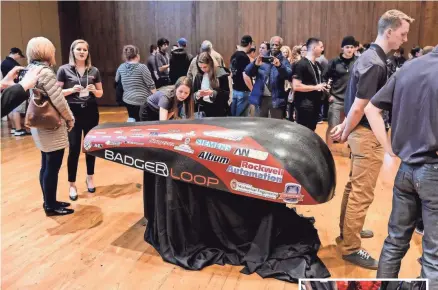  ?? PHOTOS BY JEFF MILLER / UNIVERSITY OF WISCONSIN-MADISON ?? The carbon-fiber cover of Badgerloop Pod III is pictured as the UW-Madison Badgerloop team reveals its in-progress design during a public event attended by several hundred people at the Varsity Hall in Union South at the University of Wisconsin-Madison...