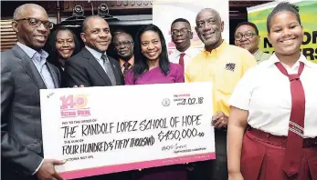  ?? RUDOLPH BROWN/PHOTOGRAPH­ER ?? Peter Reid (left), chief executive officer (CEO) of building society operations at VMBS, and Courtney Campbell, (third left), president and CEO of Victoria Mutual, hand over the National Leadership Prayer Breakfast cheque to Linton Smith (third right),...