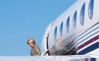  ?? CAROLYN KASTER/ASSOCIATED PRESS ?? Democratic presidenti­al candidate Hillary Clinton arrives on her campaign plane at Martha’s Vineyard Airport in Vineyard Haven, Mass., on Saturday, en route to a fundraiser.